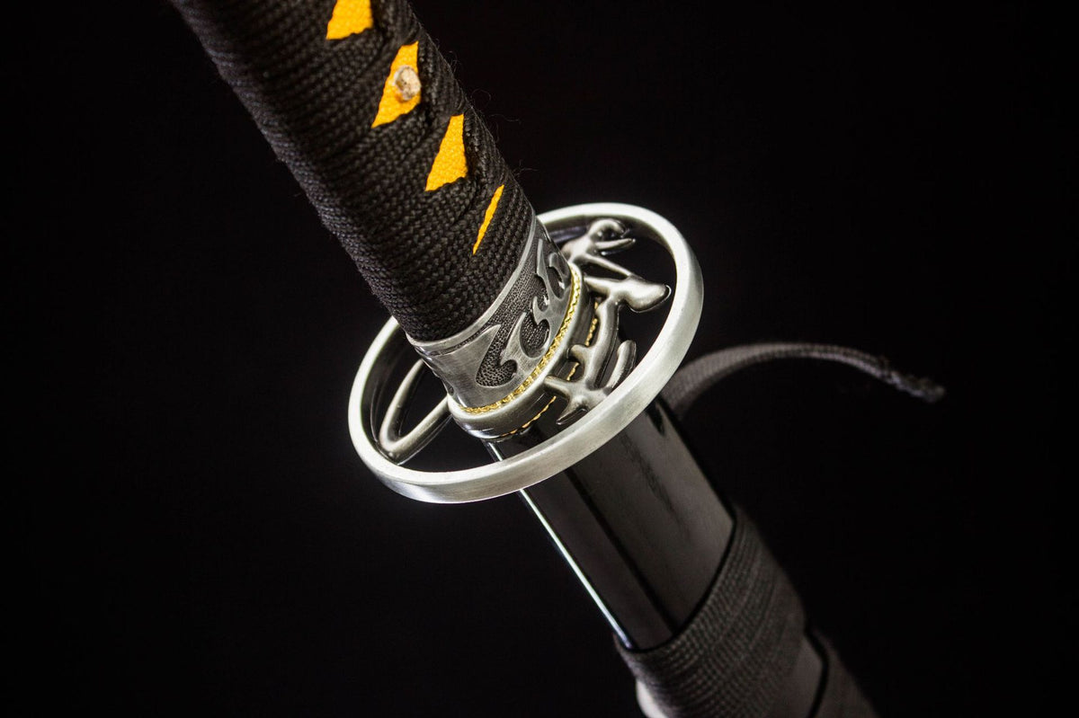 Close-up of the Gilded Dragon Katana’s black and gold handle wrap with an ornate end cap