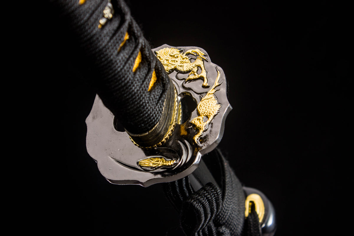 Detail view of the Gilded Coil Katana, showing the etched silver blade and black saya