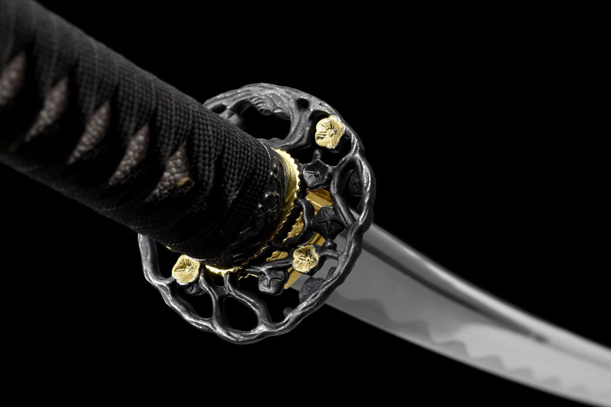 Close-up of Kuro Katana openwork floral-style guard with gold-tone accents