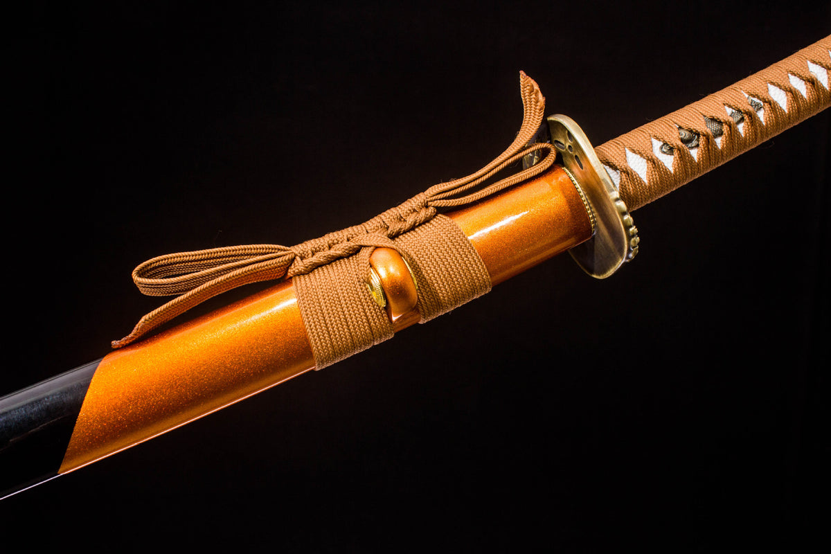 Detail view of the Sakura in Gold Katana, showing the gold-finished blade and orange handle