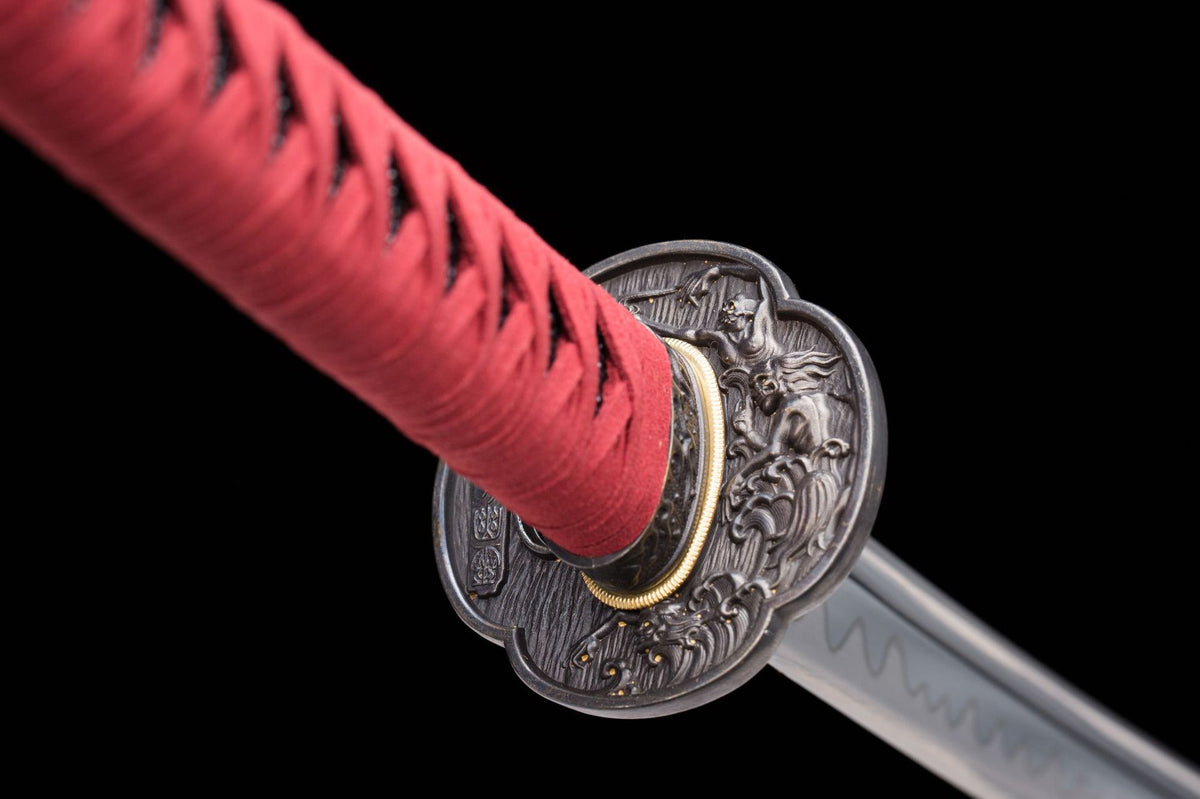 Guard and fitting detail with the blade hamon visible behind the tsuba