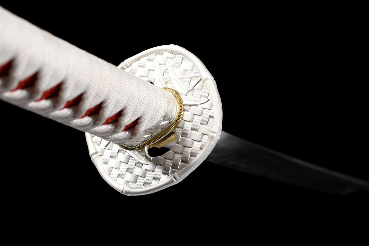 Close view of the white and silver-colored tsuba and wrapped handle