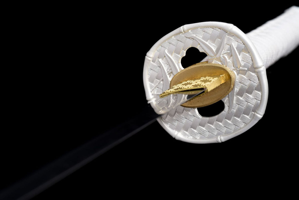 Close view of the openwork tsuba and gold-toned blade collar
