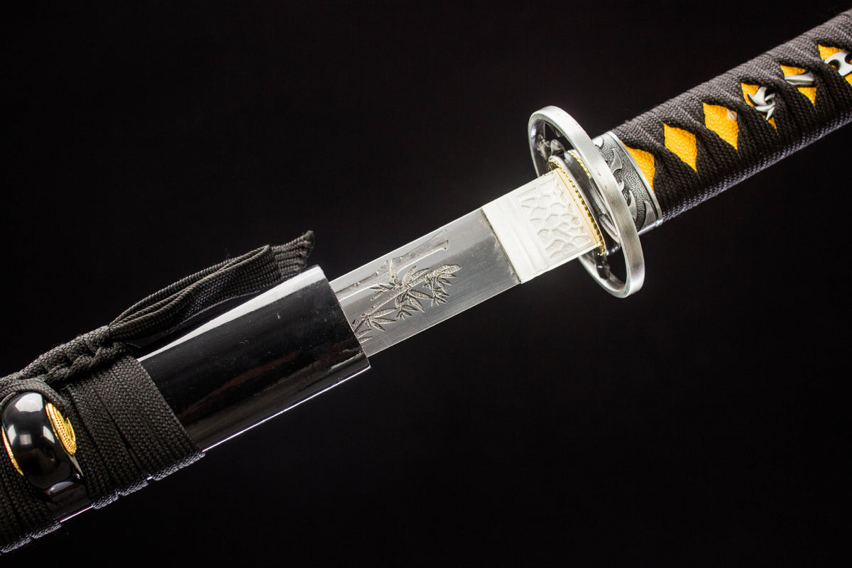 Detail view of the Gilded Dragon Katana, showing the polished blade and black decorated saya