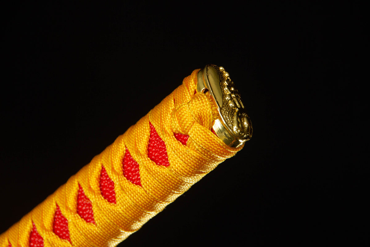 The Twin Rivers Katana with the warm patterned mounting and fittings