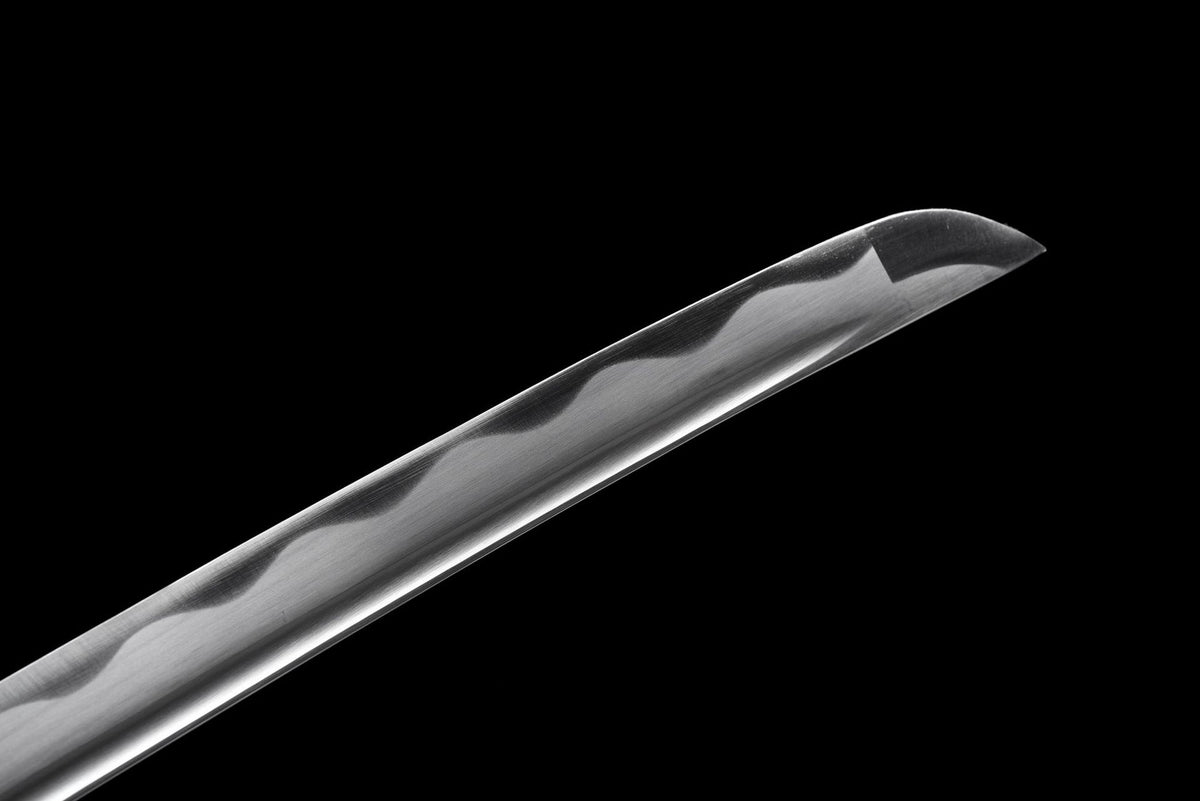 Close-up of Kuro Katana blade tip with polished finish and visible wave-like line