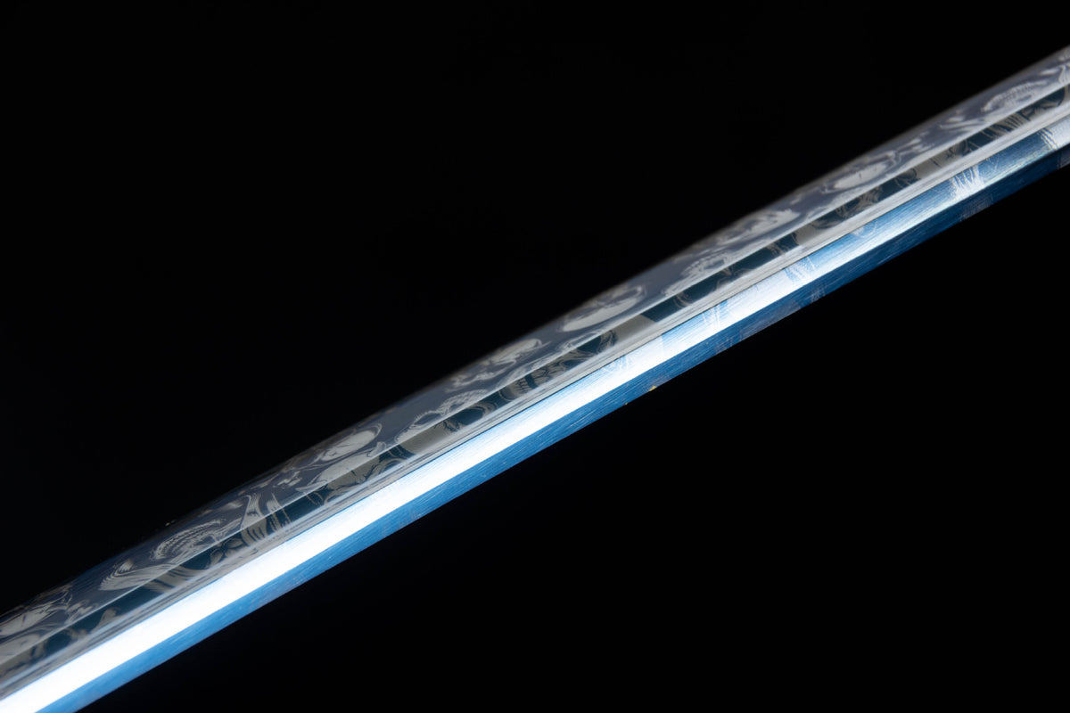 Detail view of the Inkstorm Katana, showing the blue handle wrap and dark iron tsuba