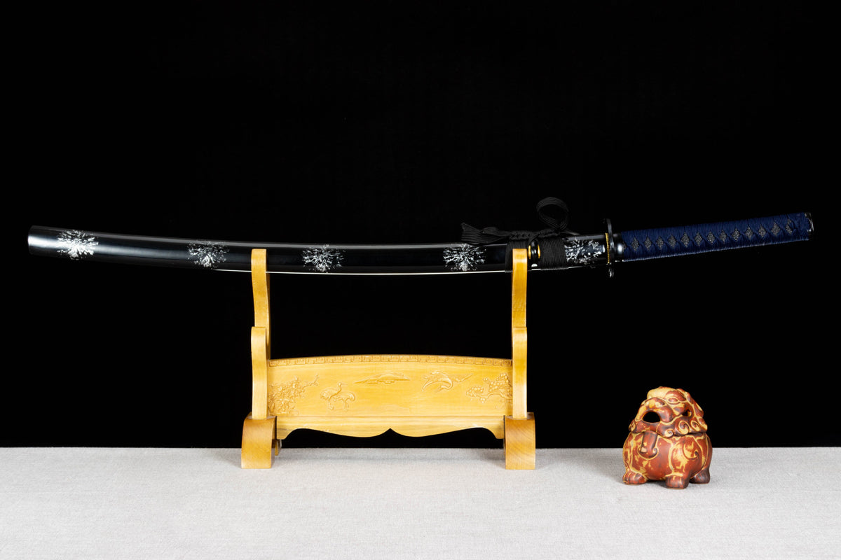 Inkstorm Katana sheathed with a glossy black saya covered in repeating silver floral motifs