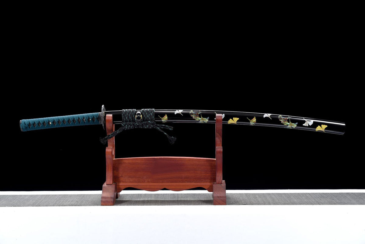 Garden at Dusk Katana displayed sheathed with a glossy black saya and blue handle wrap