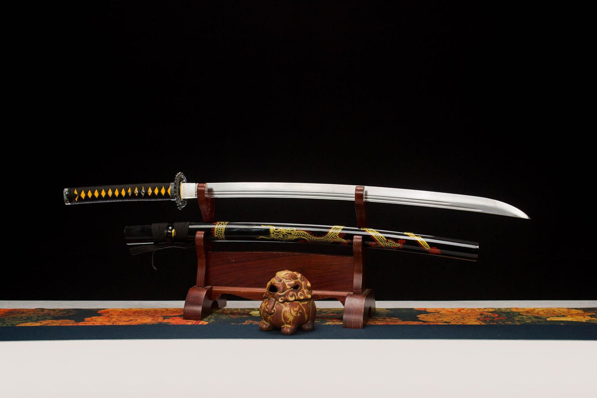 Night Coil Katana displayed unsheathed with a silver blade and black saya carrying a gold serpentine motif