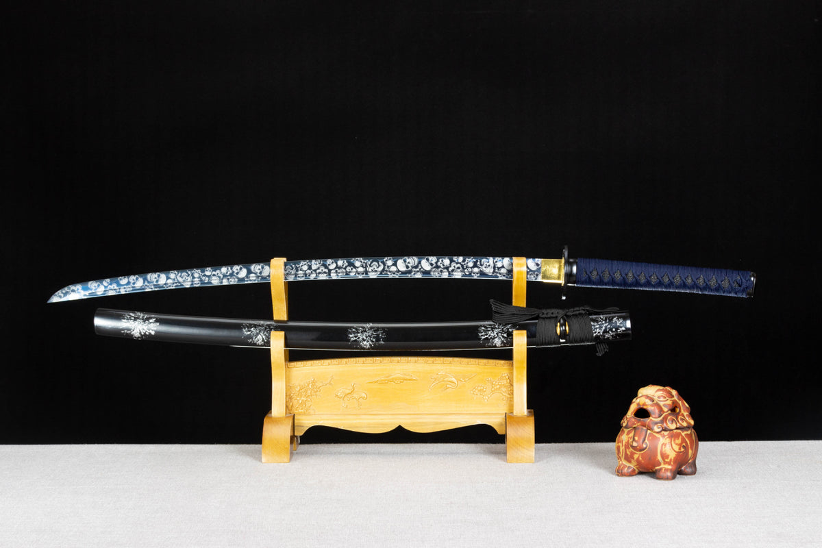 Inkstorm Katana with a blue handle, patterned blade, and glossy black saya with silver motifs