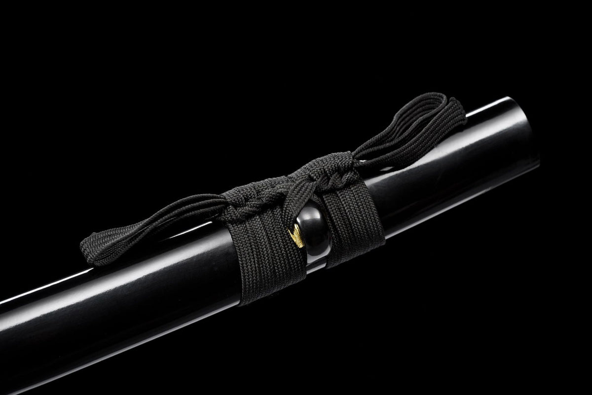 Close-up of Kuro Katana black cord knot and glossy black painted wood saya