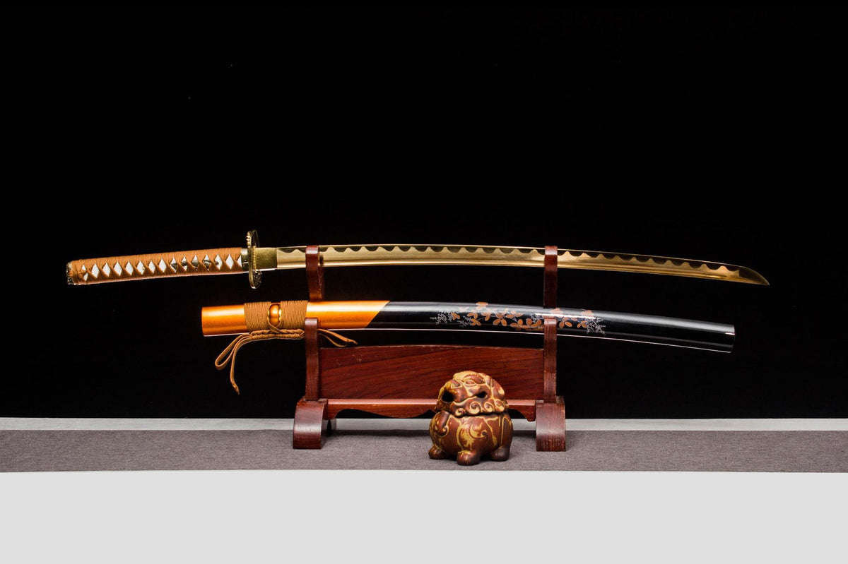 Sakura in Gold Katana with a gold-toned blade, black and orange saya, and sakura motif