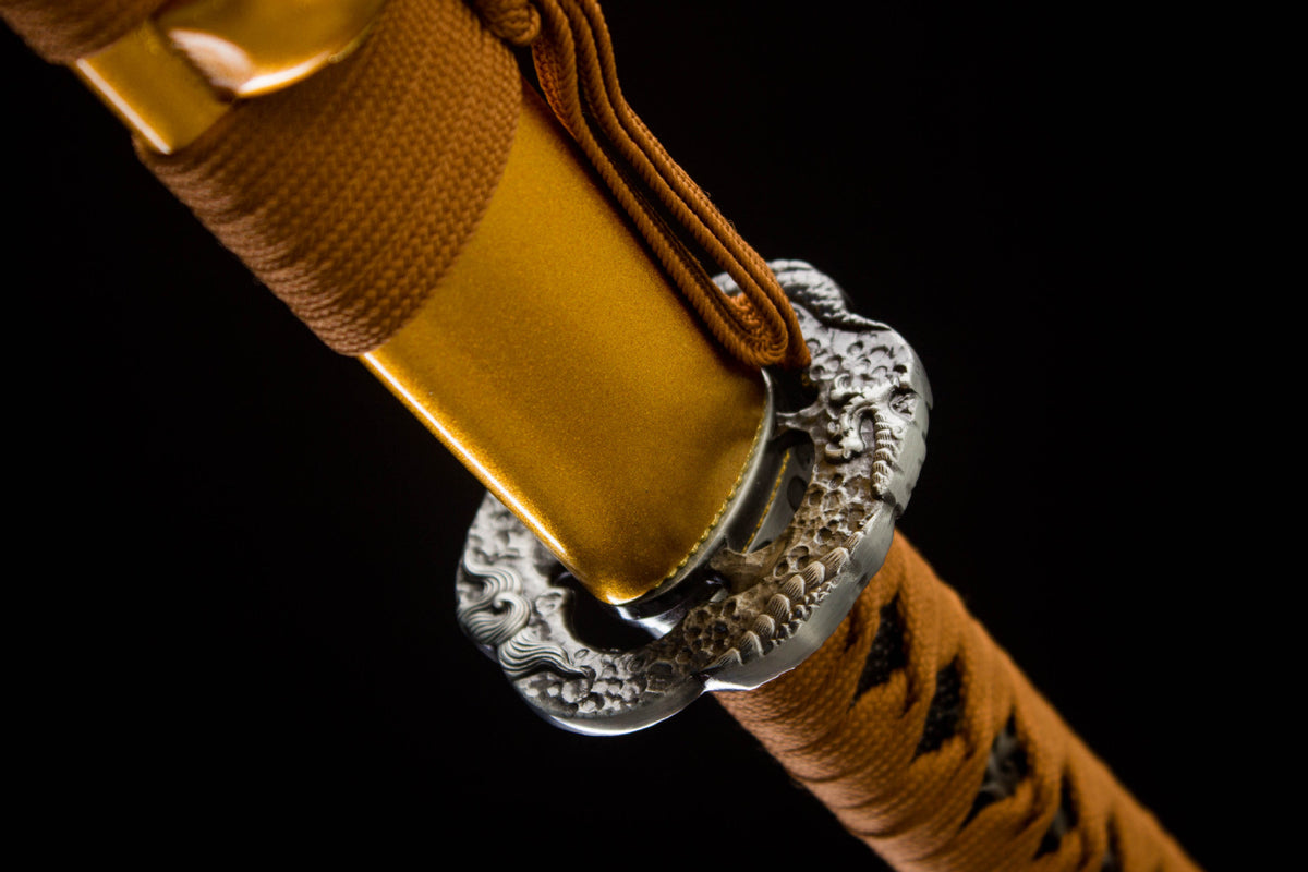 Heat-cured gold blade with decorative wave pattern and longitudinal fuller