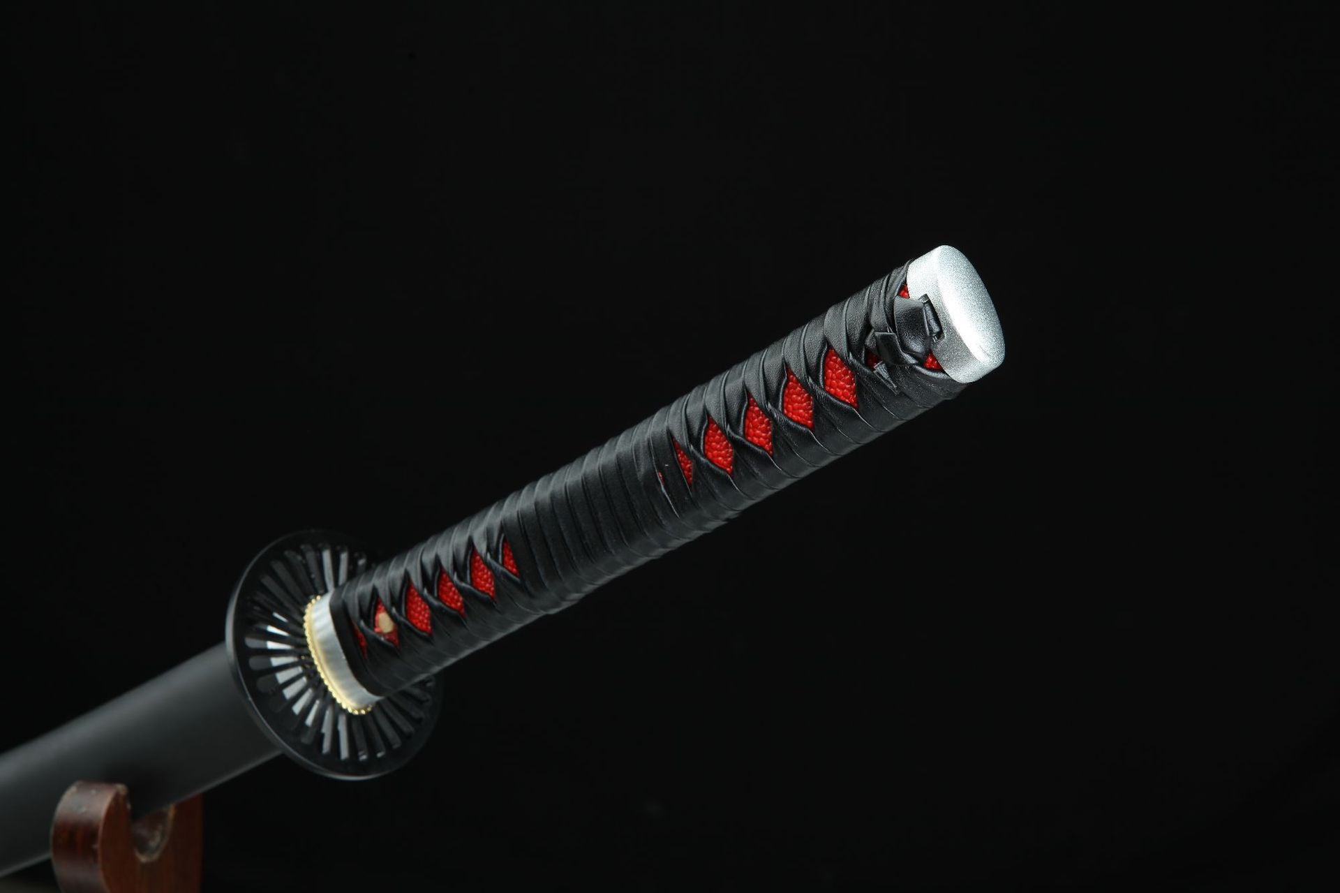Showcase of Tanjiro's first Nichirin blade handle, featuring intricate designs and details.