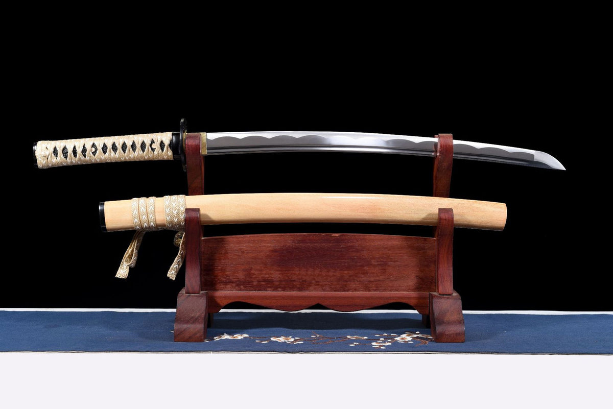 Woodheart Wakizashi, full view of the dark blade, ivory handle wrap, and pale wood saya