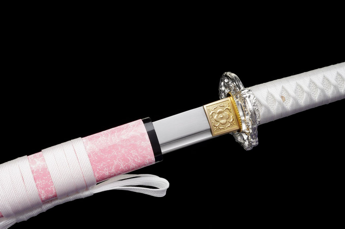 Blush Sakura Katana partially drawn beside its sakura fittings and saya opening