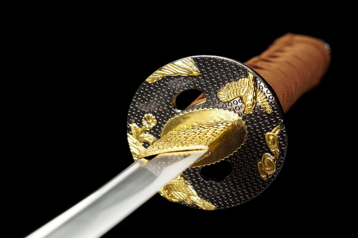 Close-up of the black-and-gold tsuba on the Nightingale wakizashi
