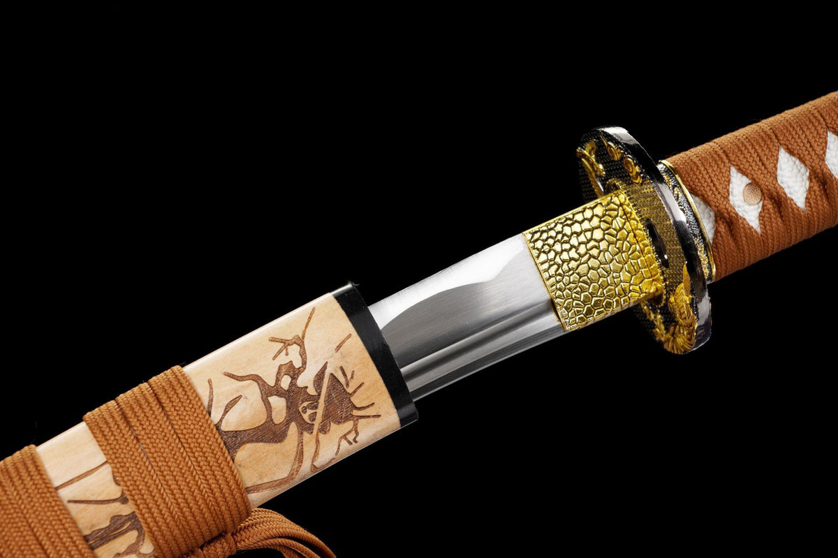 Gold-tone habaki and carved wood saya beside the blade