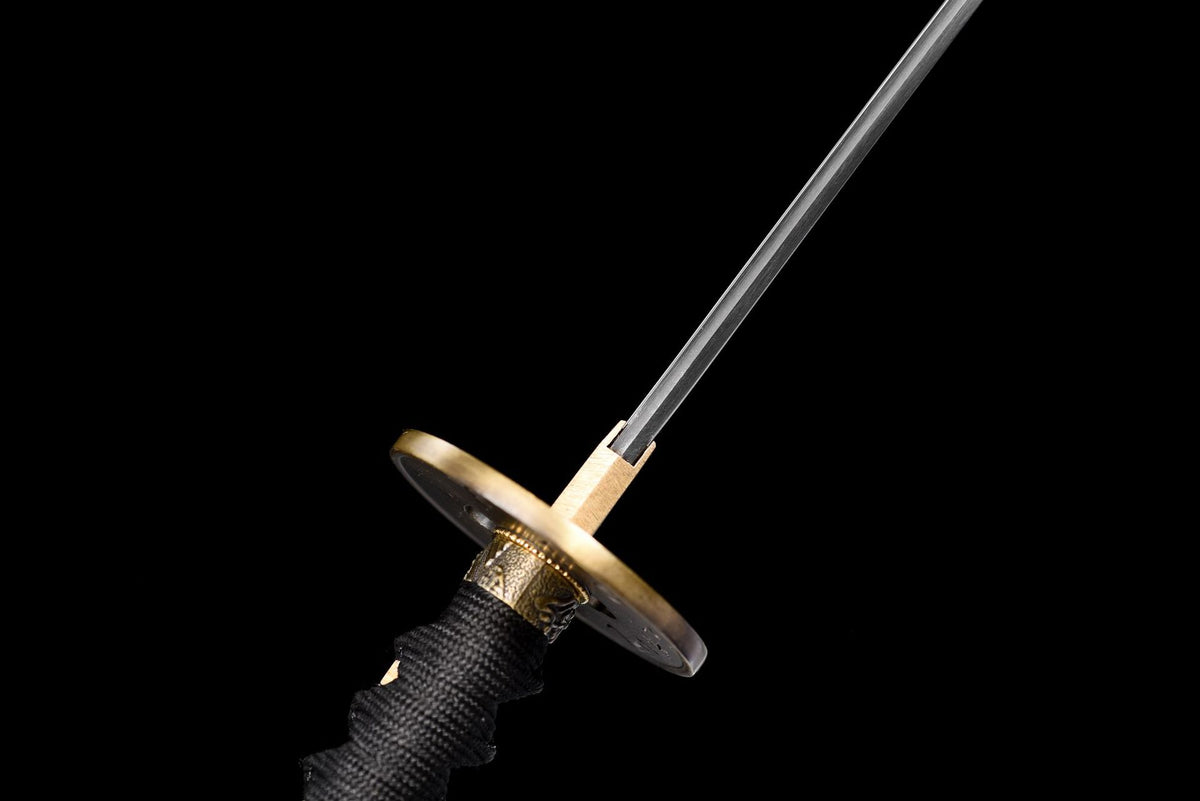 Angled view along the polished katana blade and round warrior tsuba