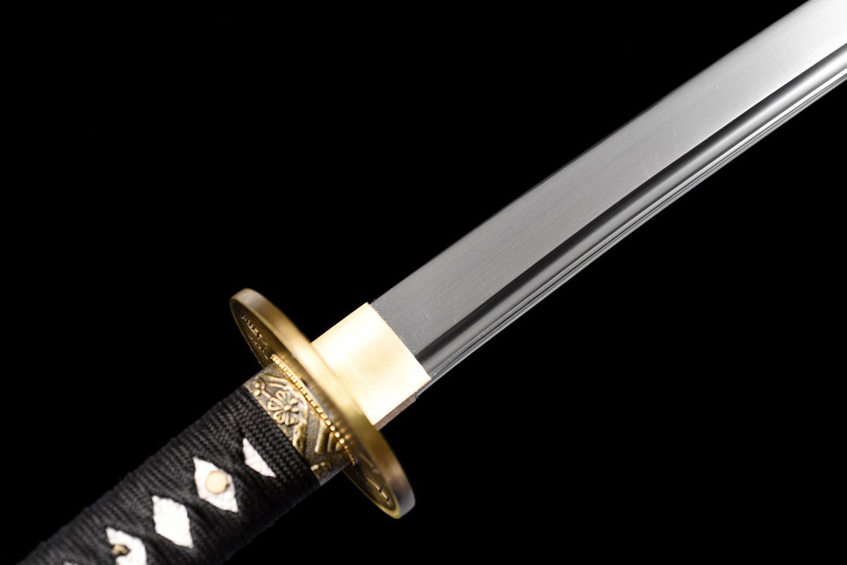 Blade base showing the long bo-hi, gold-tone habaki, and black wrapped tsuka