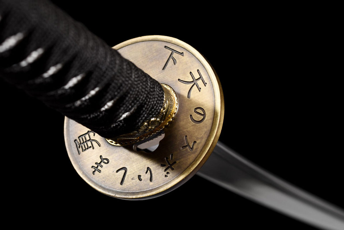 Reverse of the round tsuba with engraved Japanese characters