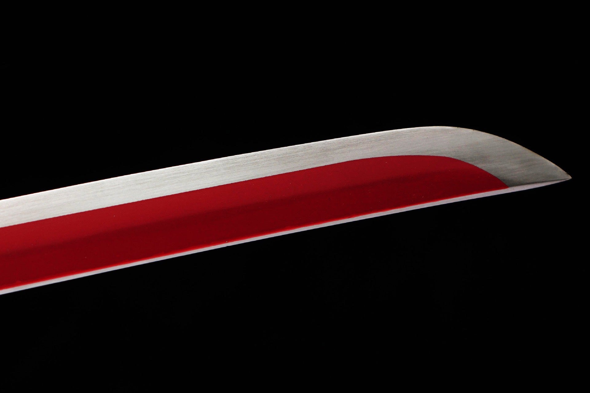 Red-and-white decorative blade surface near the curved tip