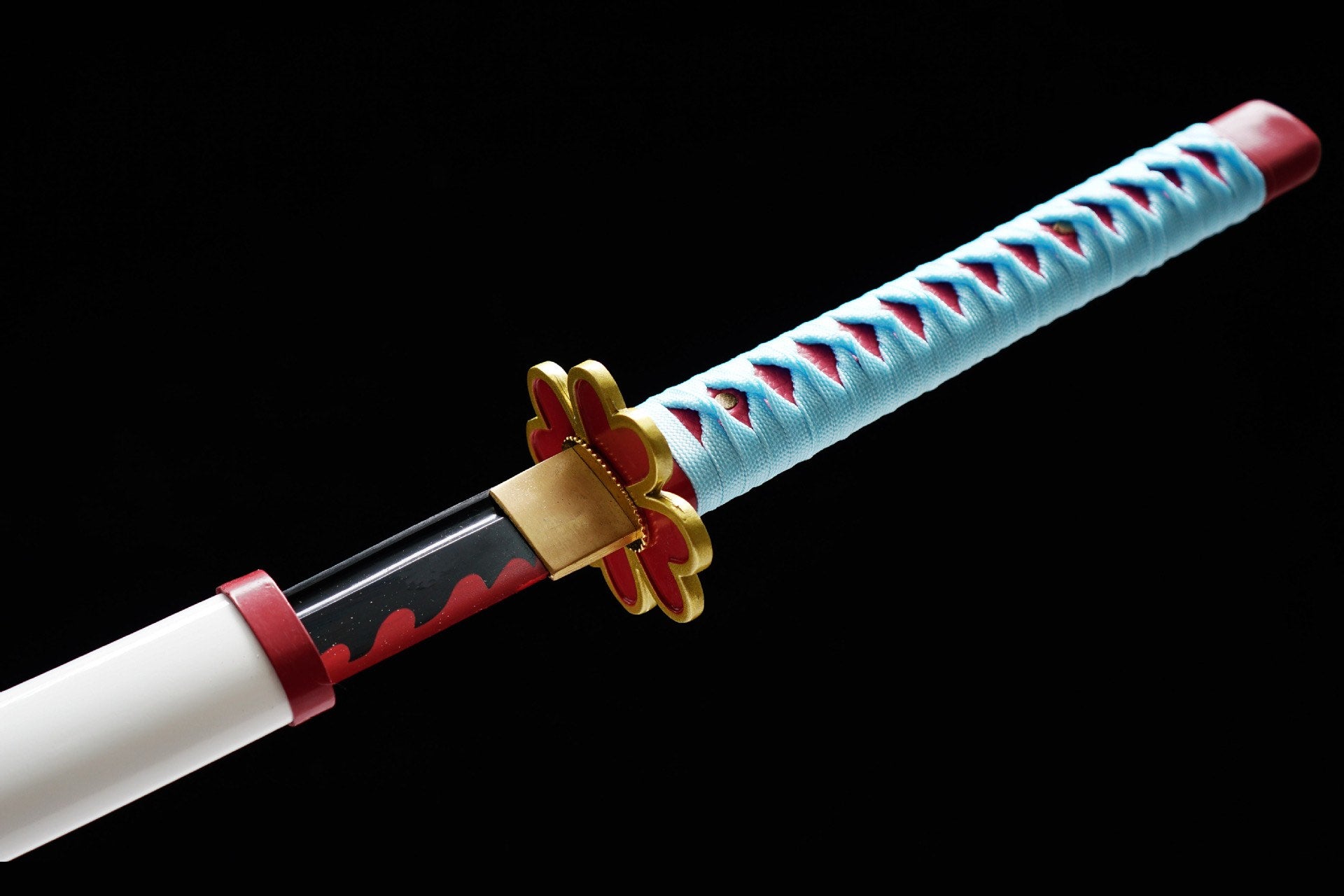 Red-and-gold heart-shaped guard beside the pale blue-wrapped handle