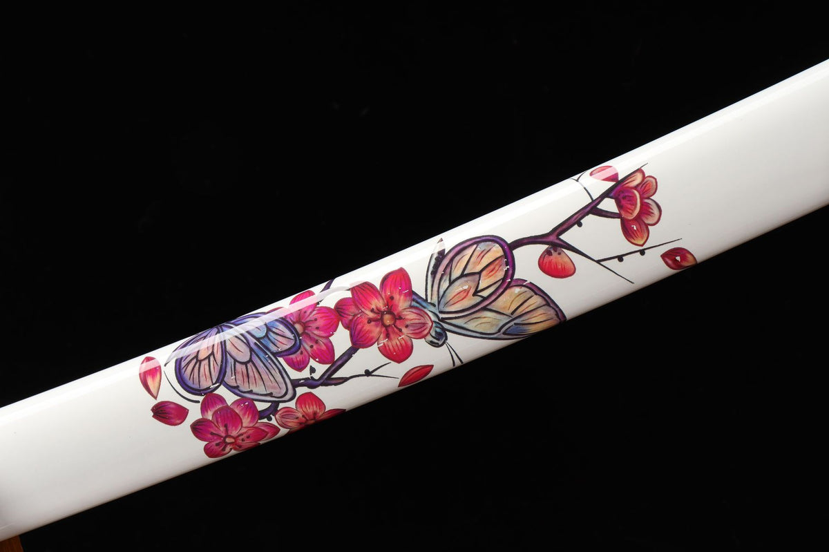Butterfly and blossom artwork on the white lacquered saya