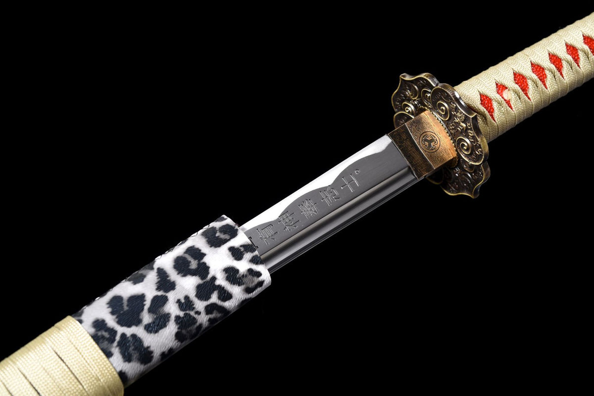 Gold-toned habaki, antiqued floral tsuba, and leopard-pattern saya