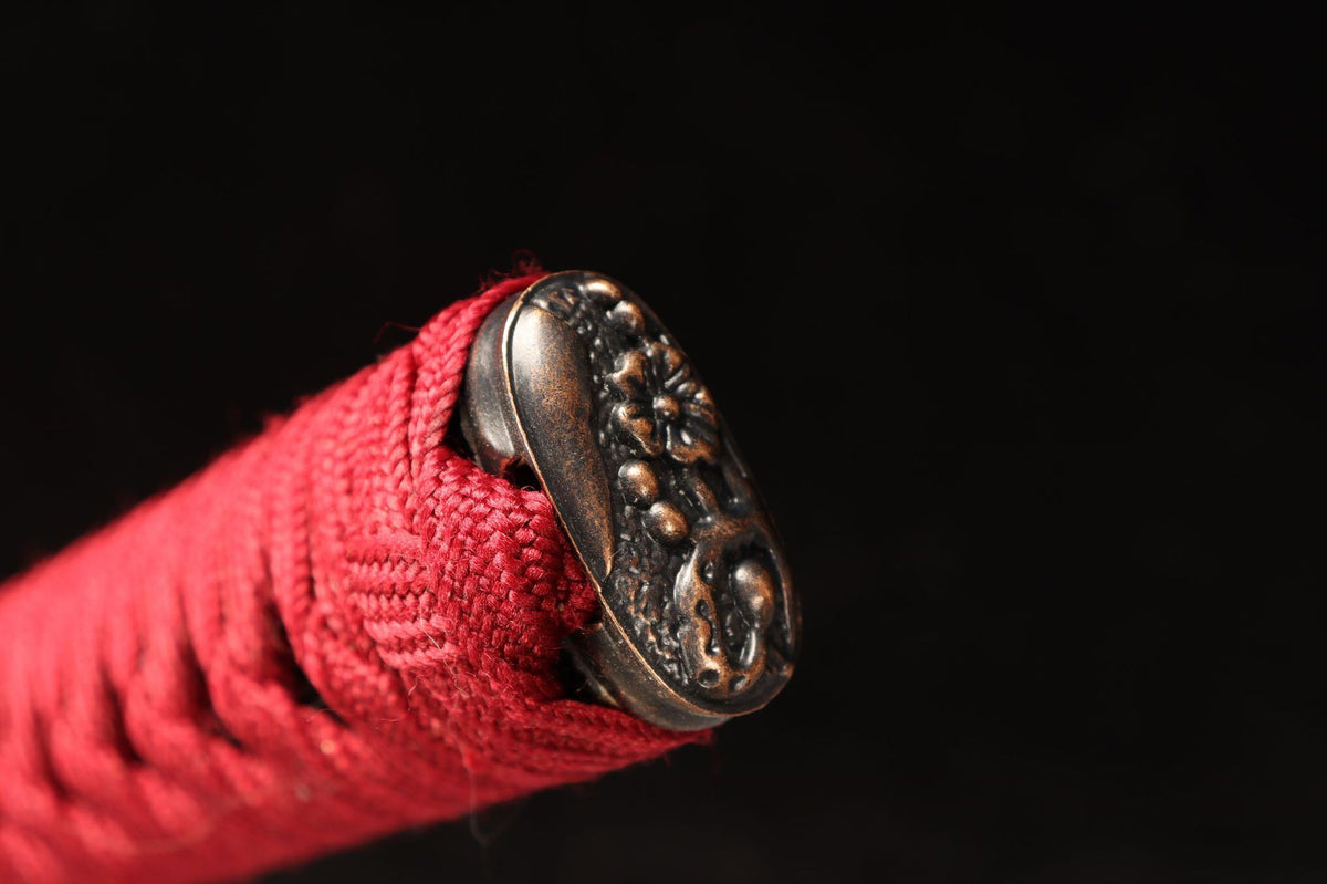 Floral kashira detail and red wrapping on the Lotus Return Katana