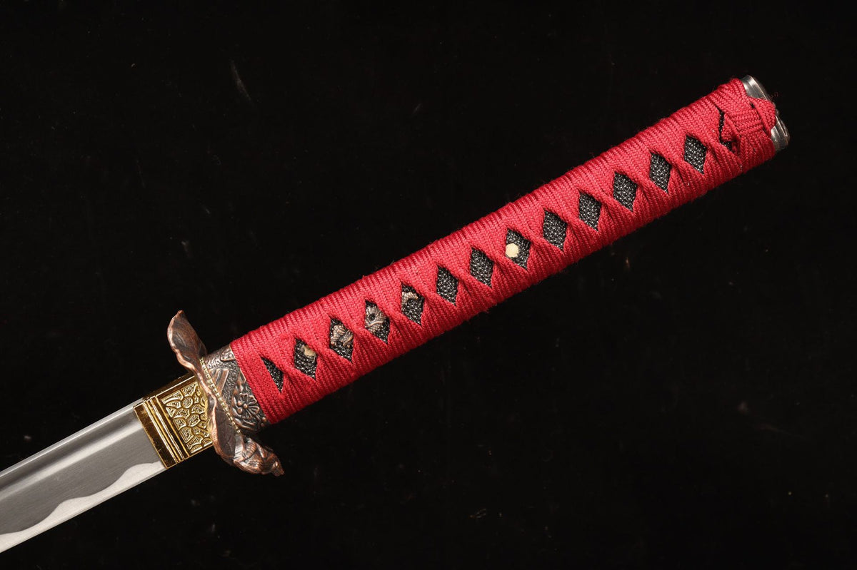 Red-wrapped tsuka with black textured panels and relief fittings
