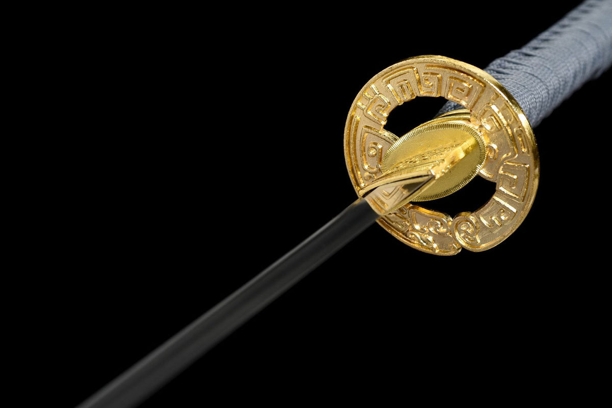 Geometric openwork tsuba and patterned habaki on the Olive Stone Katana