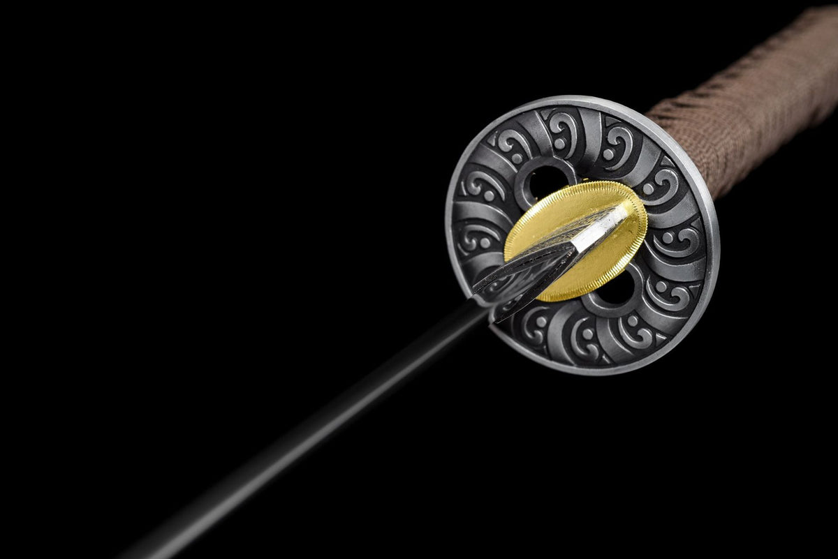 Round scrollwork tsuba and warm-toned habaki on the Russet Scroll Katana