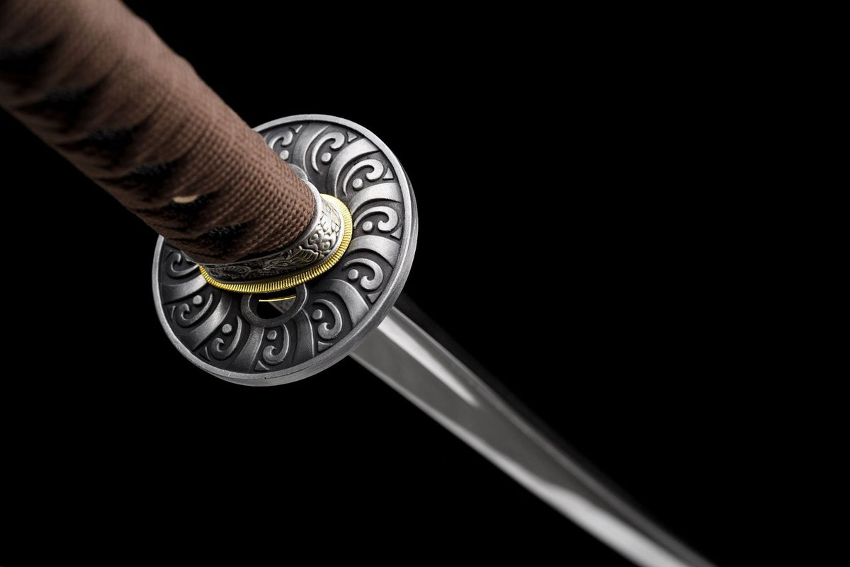 Reverse view of the round alloy tsuba and brown tsuka wrap