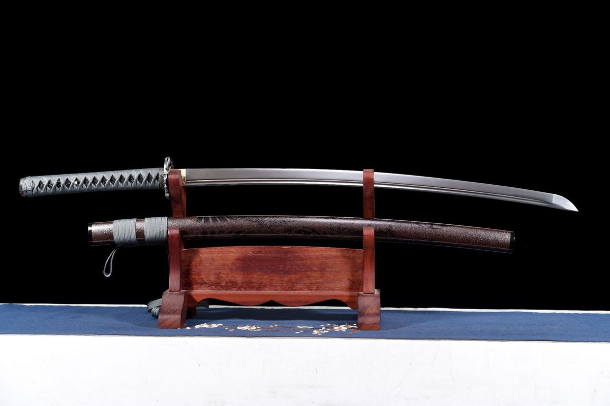 Silent Warrior Katana displayed beside its dark brown patterned saya