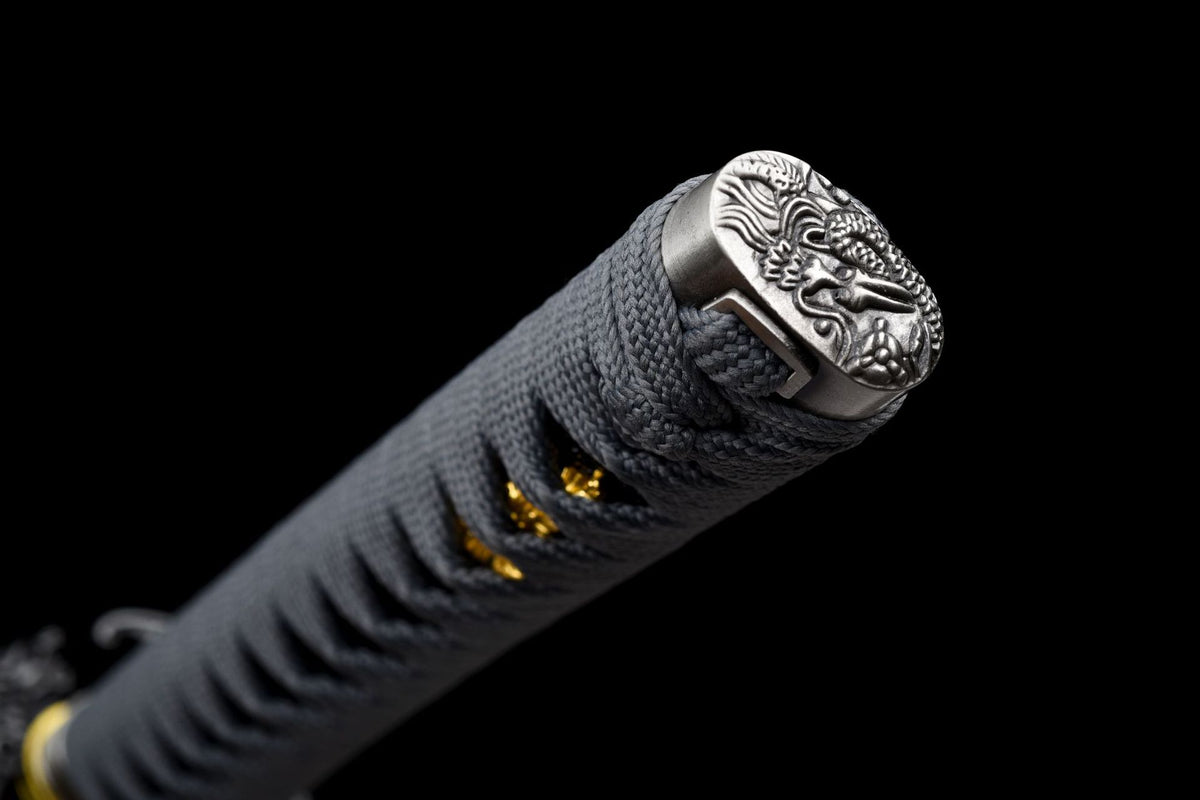 Dragon-decorated kashira on the grey-wrapped handle