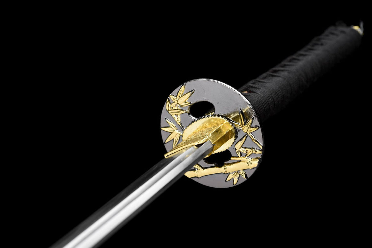Close view of bamboo-leaf alloy fittings and gold-toned blade collar