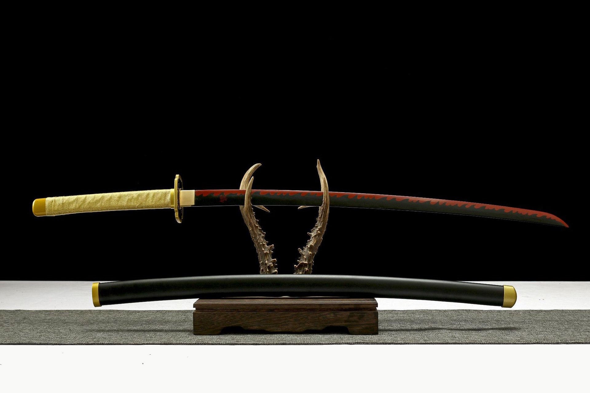Full view of Yoriichi Tsugikuni Katana with black-and-red blade, gold handle wrap, and black scabbard