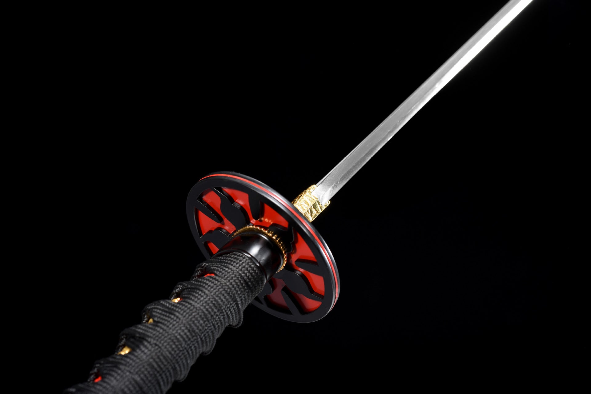 Close-up of the black-red iron tsuba showcasing intricate design and craftsmanship.