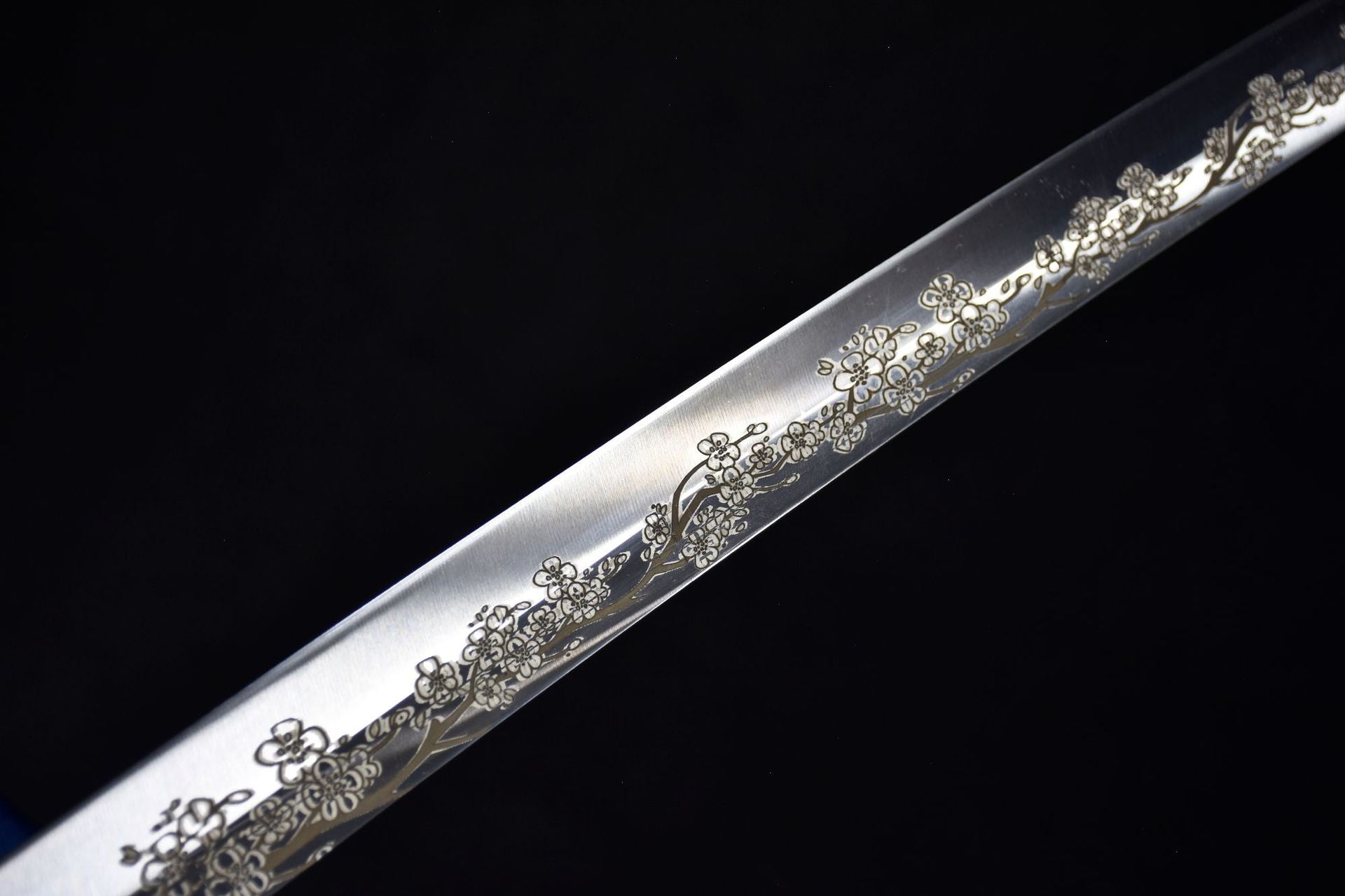 A close-up of Sakura engraving on a katana blade