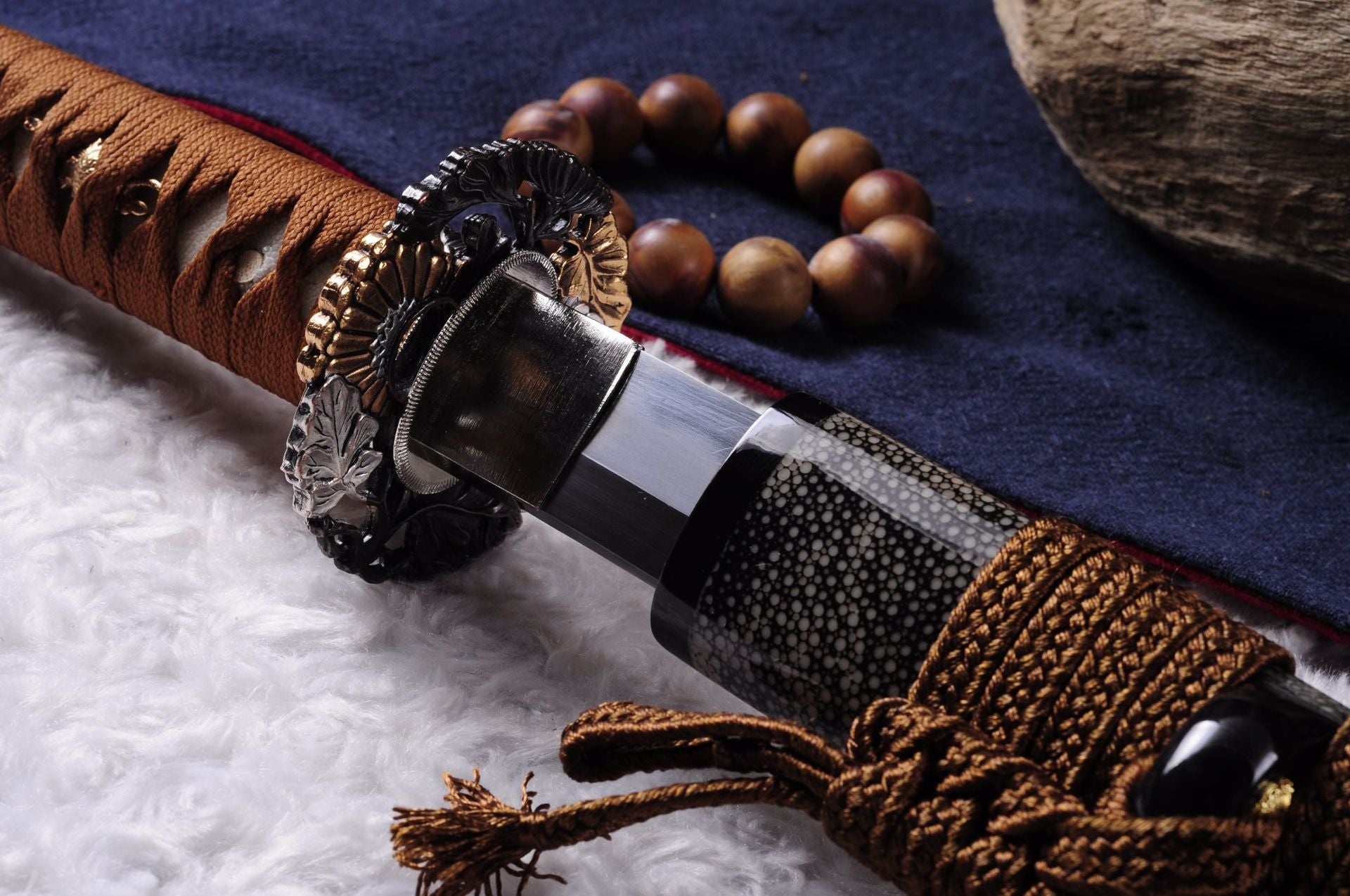 Detailed view of Daisy katana fittings including tsuba, ray skin wrapped tsuka, and decorative metal accents.