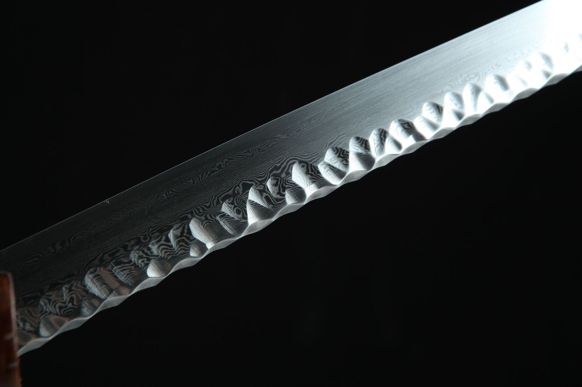 Close-up view of a Damascus steel katana blade edge showcasing the detailed folded pattern and sharp finish.