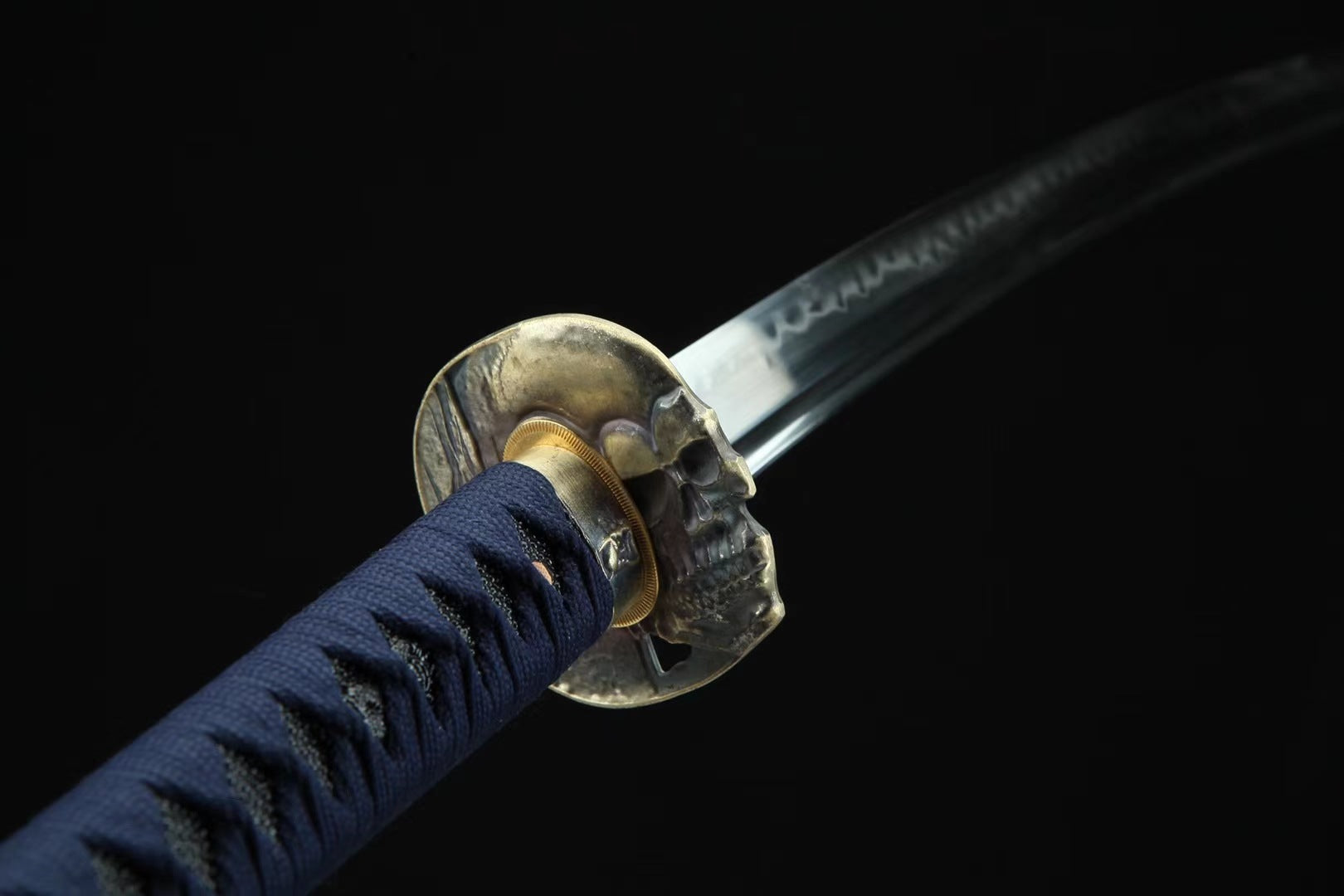 Close-up of the skull-shaped tsuba on the "Devil" katana, highlighting its unique and striking design.