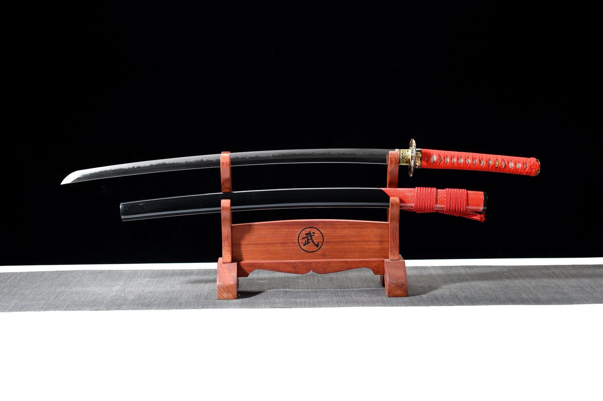 Fire Kirin katana with a red handle and black sheath.