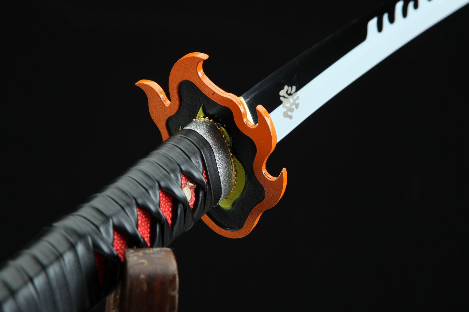 Close-up of Flame Hashira’s guard on Tanjiro’s Nichirin sword, shown from the hilt perspective.