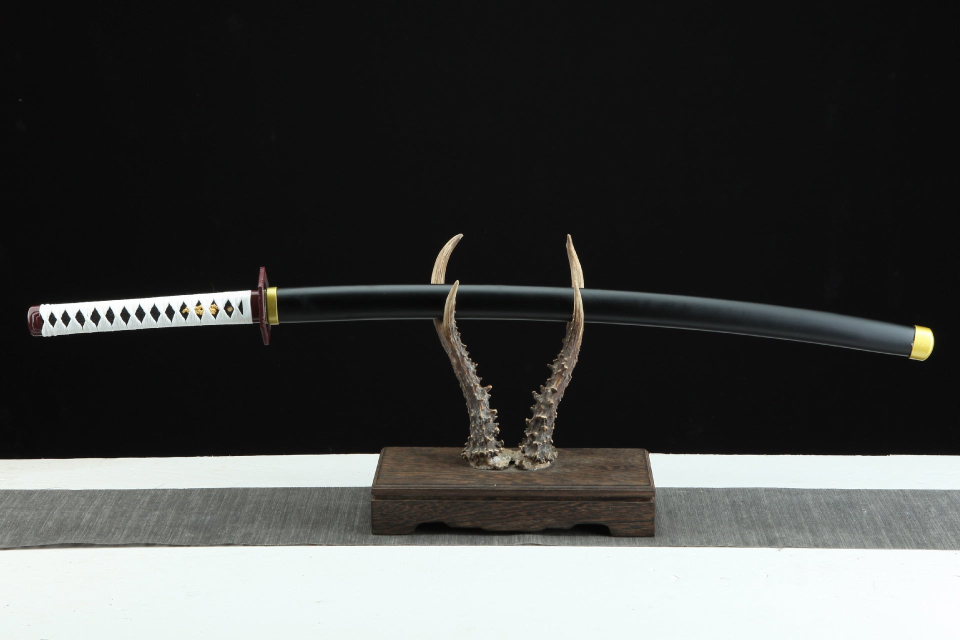 Giyu’s Nichirin Sword displayed on a stand.