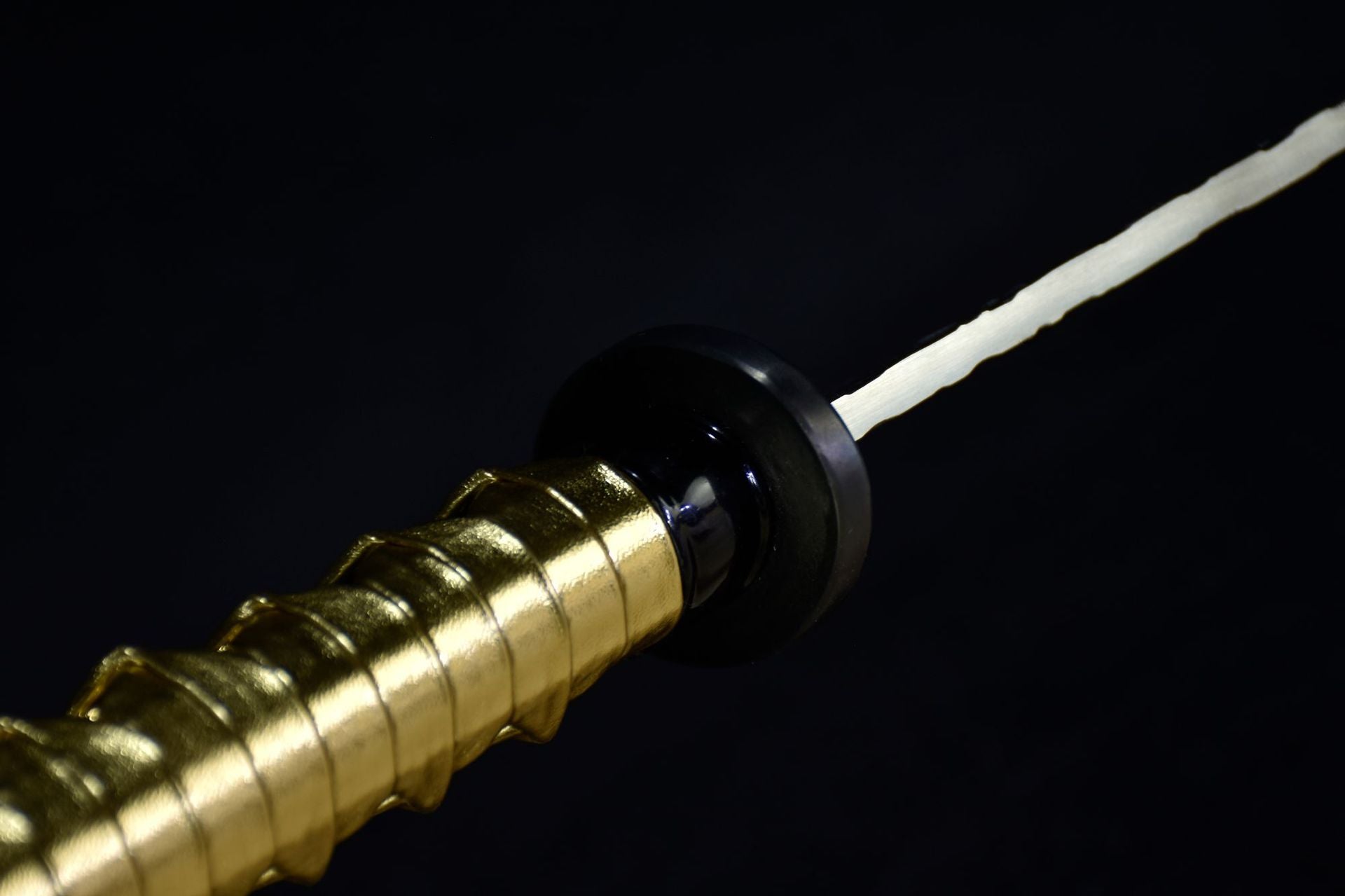 Close-up of the golden Samurai handle and black Tsuba.