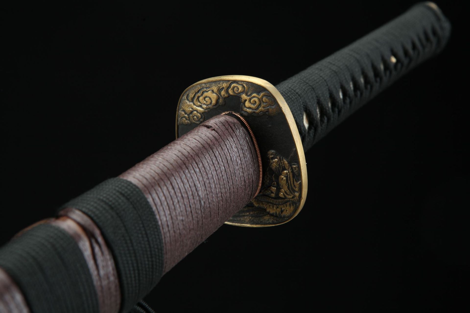 Close-up of the Jiang Tai Gong katana featuring an ornate brass tsuba with cloud motifs and detailed carvings.
