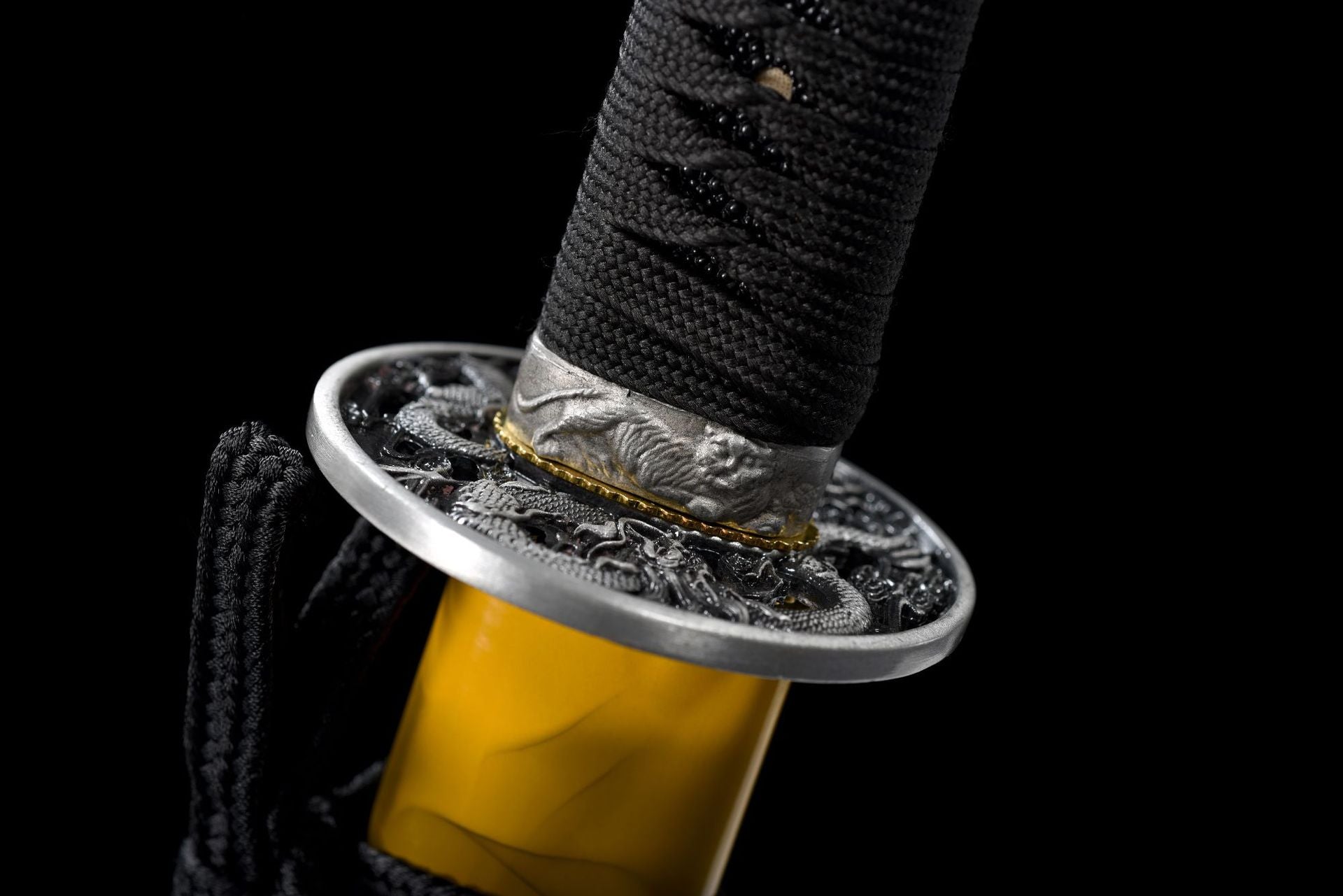 Close-up of the katana fuchi, highlighting its intricate design and craftsmanship on the guard fitting.